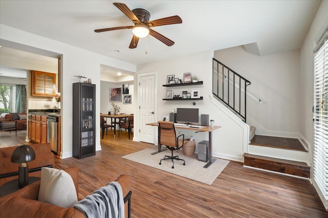 office with baseboards, dark wood finished floors, and a ceiling fan