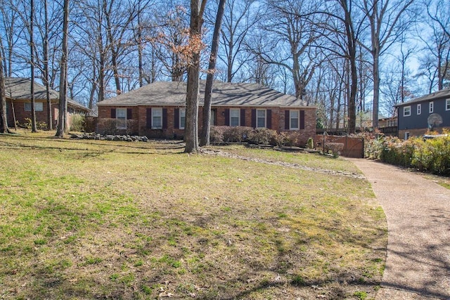 ranch-style home with brick siding and a front yard