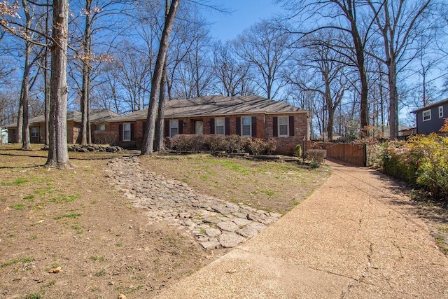 ranch-style house featuring brick siding