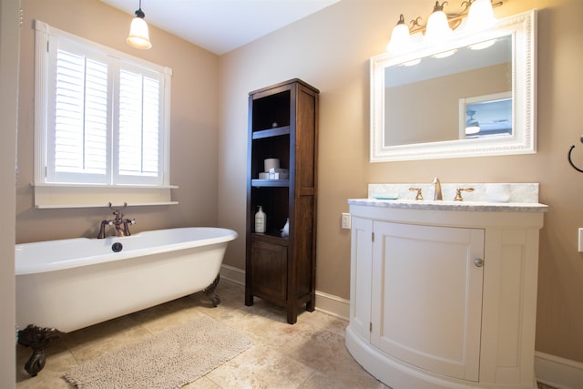 full bathroom featuring a soaking tub, vanity, and baseboards