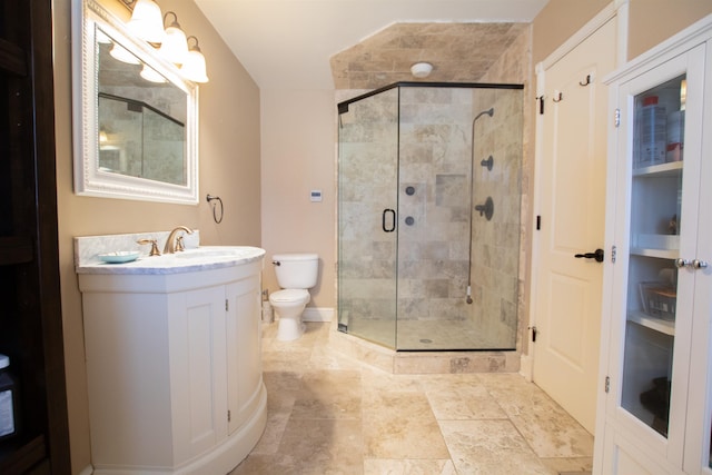 bathroom with vanity, toilet, and a shower stall