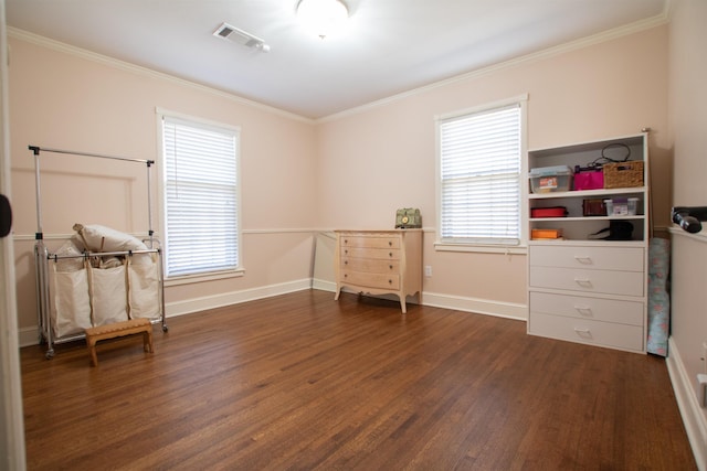 interior space featuring a healthy amount of sunlight, wood finished floors, and ornamental molding