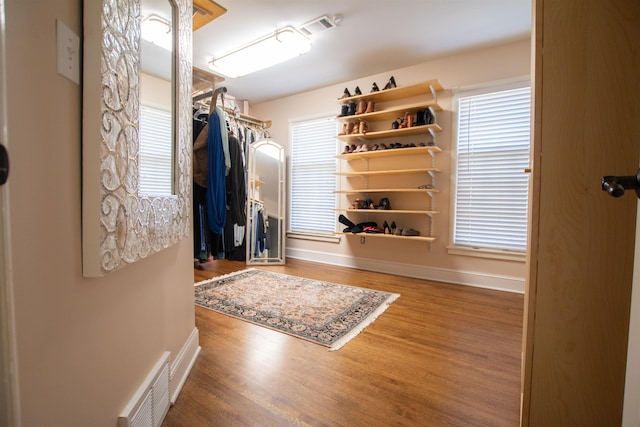 walk in closet with wood finished floors and visible vents