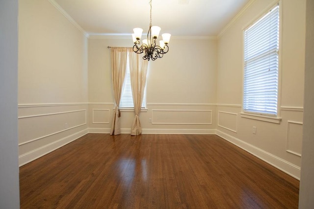 unfurnished room featuring an inviting chandelier, a decorative wall, crown molding, and dark wood-type flooring