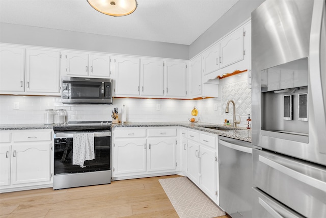 kitchen with white cabinetry, appliances with stainless steel finishes, and a sink