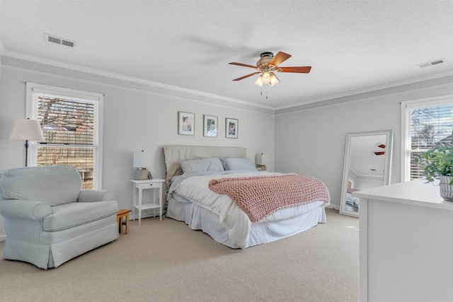 bedroom featuring crown molding, light colored carpet, and visible vents