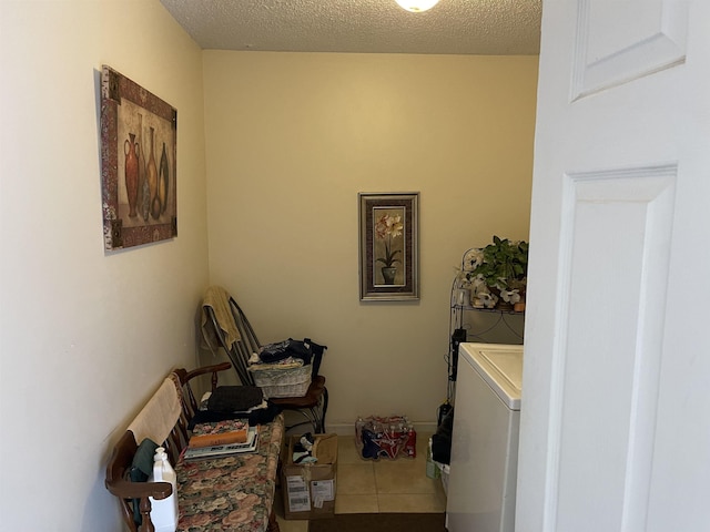 laundry area featuring washer / clothes dryer, a textured ceiling, and laundry area