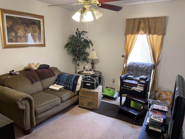 living room featuring carpet and a ceiling fan