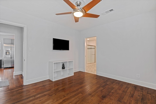 unfurnished living room with a ceiling fan, visible vents, wood-type flooring, and baseboards