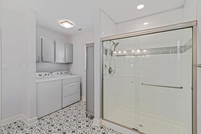 bathroom with independent washer and dryer, baseboards, and a stall shower