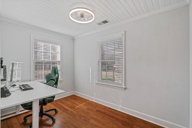 office space with a wealth of natural light, visible vents, wood finished floors, and ornamental molding