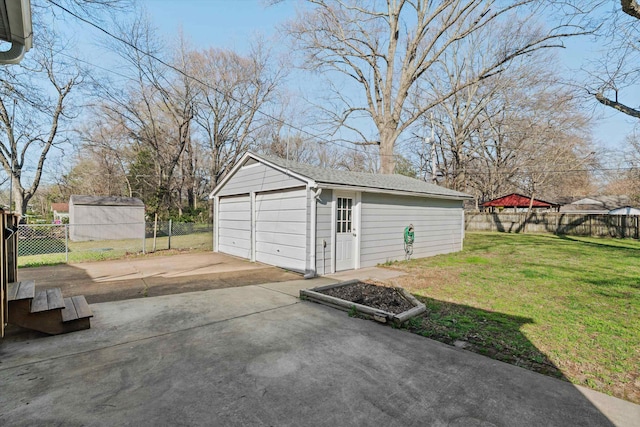 detached garage featuring fence