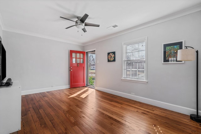 entrance foyer featuring visible vents, crown molding, ceiling fan, and hardwood / wood-style floors