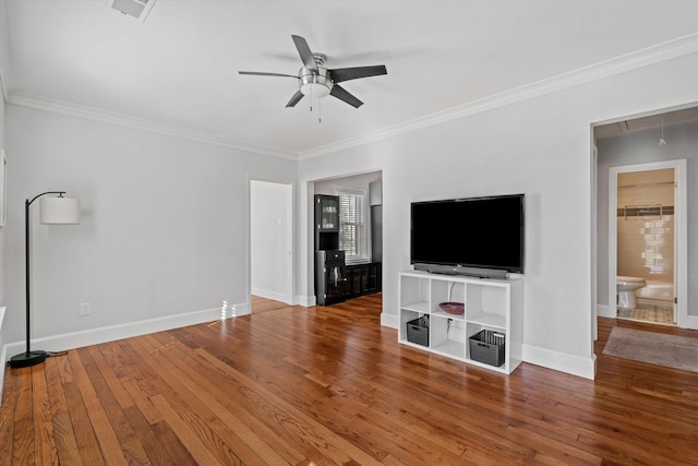 unfurnished living room featuring attic access, crown molding, ceiling fan, and hardwood / wood-style flooring