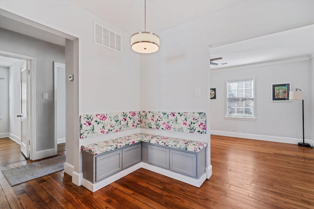 dining area featuring breakfast area, visible vents, baseboards, and dark wood-style flooring