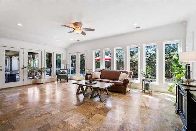 living area featuring a wealth of natural light, french doors, visible vents, and ceiling fan