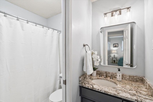 full bath with curtained shower, toilet, and vanity