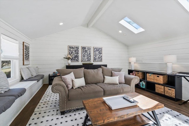 living room with lofted ceiling with skylight and wood finished floors