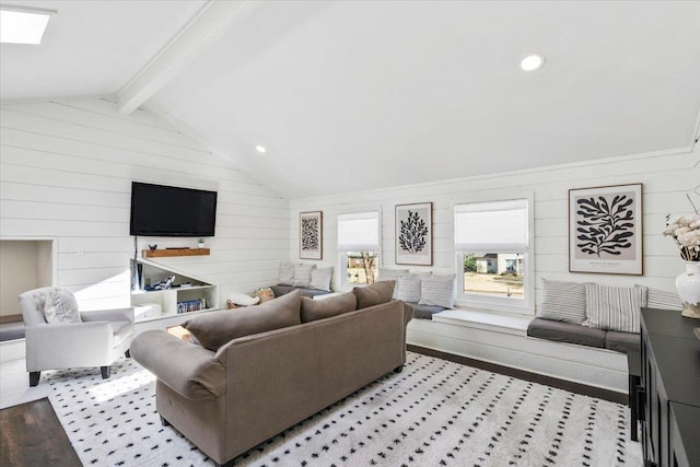 living area featuring lofted ceiling with skylight and wood finished floors