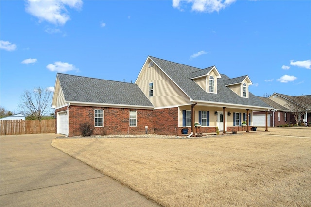 view of front of house featuring brick siding, a shingled roof, fence, concrete driveway, and a garage