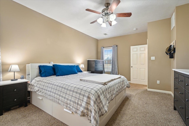 bedroom featuring baseboards, light carpet, visible vents, and ceiling fan