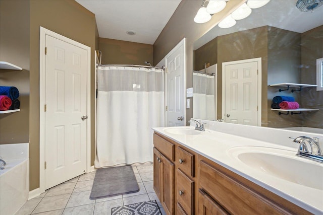 bathroom with tile patterned floors, double vanity, a bathing tub, and a sink