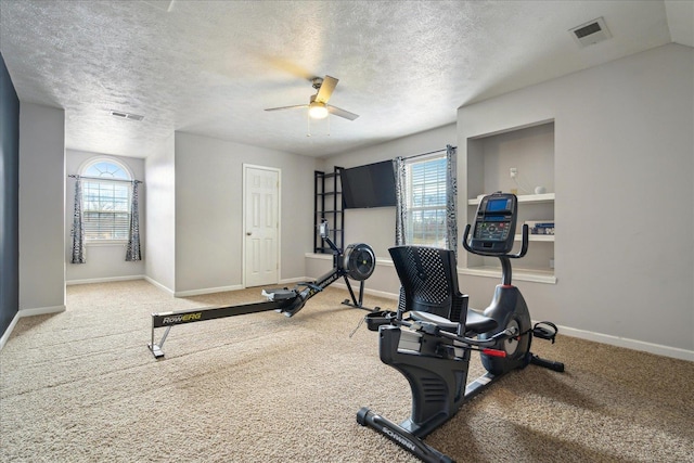 exercise room featuring visible vents, baseboards, carpet, and a ceiling fan