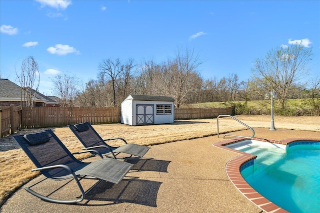 view of pool featuring a storage shed, an outbuilding, a fenced in pool, and a fenced backyard