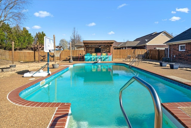 view of swimming pool featuring a fenced backyard, a fenced in pool, and a patio