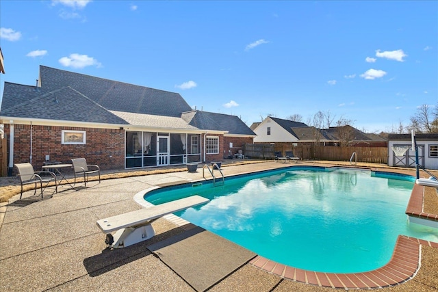 view of pool with a patio area, a fenced in pool, a fenced backyard, and a sunroom