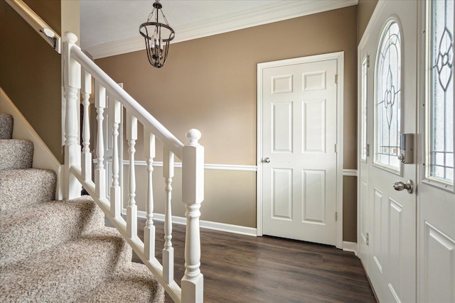 foyer with stairs, baseboards, dark wood-style flooring, and ornamental molding