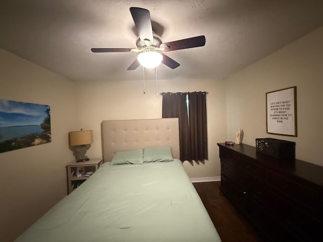 bedroom with dark wood-type flooring and ceiling fan