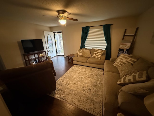 living area featuring a textured ceiling, wood finished floors, and ceiling fan