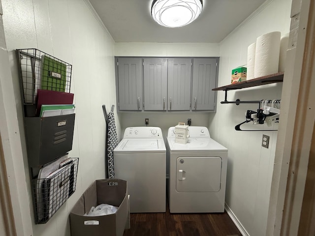 washroom featuring washer and dryer, cabinet space, dark wood finished floors, and ornamental molding