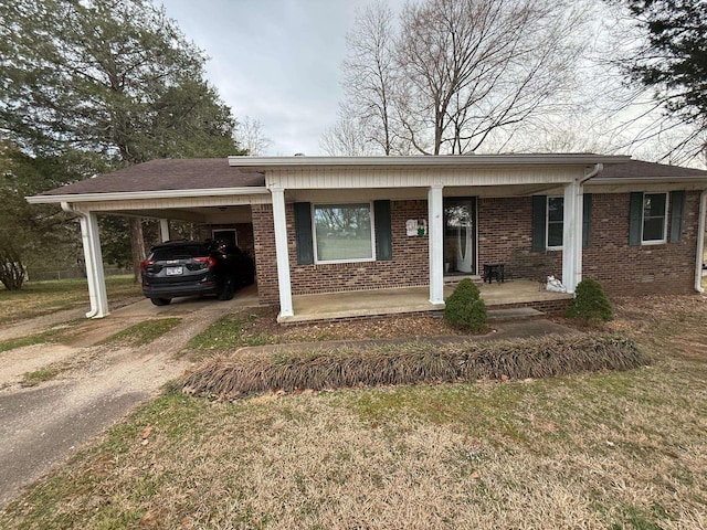 single story home with an attached carport, concrete driveway, brick siding, and covered porch