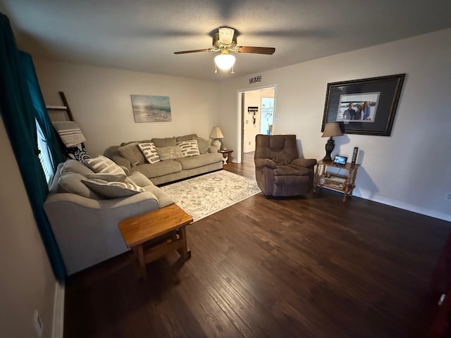 living area featuring dark wood finished floors and a ceiling fan