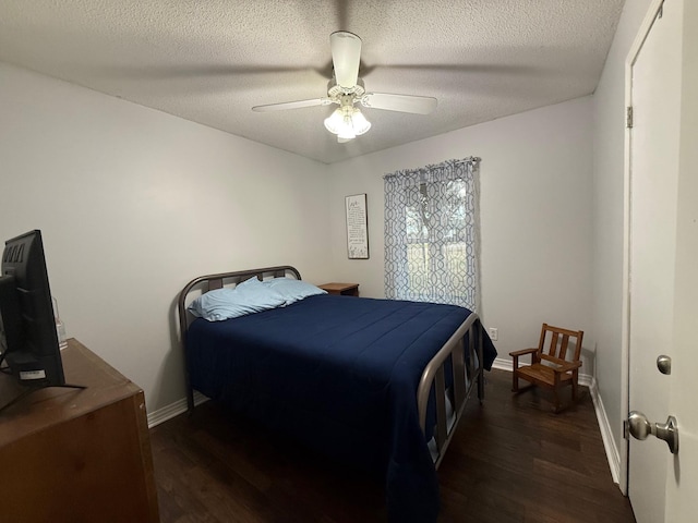 bedroom featuring ceiling fan, baseboards, a textured ceiling, and wood finished floors