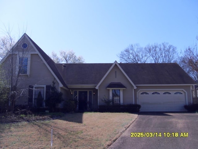 view of front of property featuring aphalt driveway and a garage