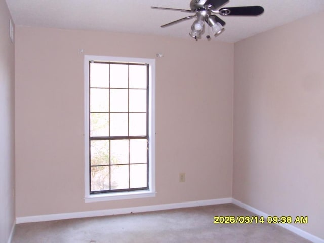 spare room featuring baseboards, carpet, and ceiling fan