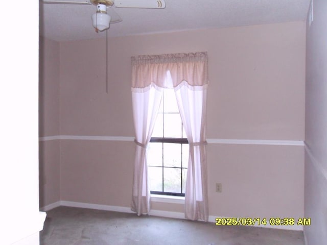 empty room featuring baseboards and a ceiling fan