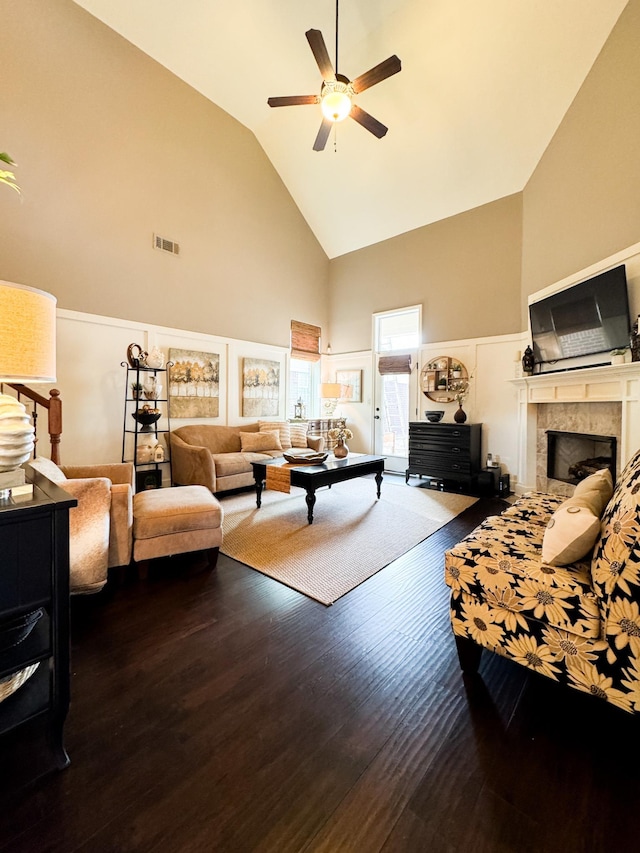 living room with visible vents, high vaulted ceiling, a ceiling fan, wood finished floors, and a fireplace