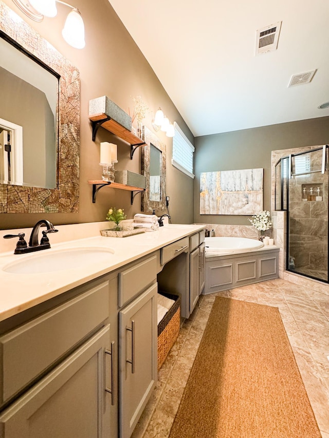 bathroom featuring plenty of natural light, a bath, visible vents, and a sink