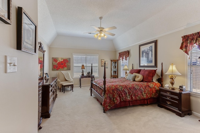 bedroom featuring light carpet, a textured ceiling, lofted ceiling, and ceiling fan