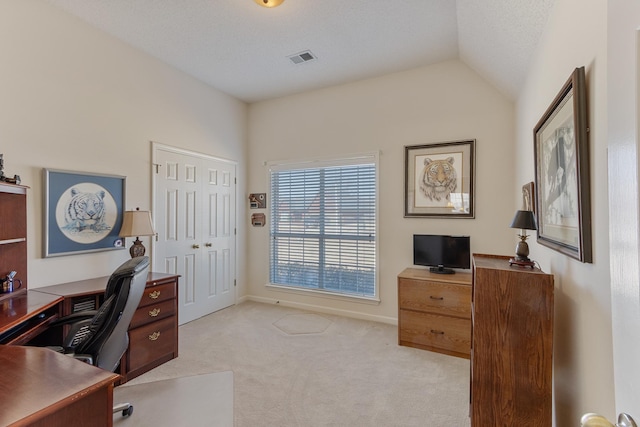 office space with visible vents, baseboards, light colored carpet, vaulted ceiling, and a textured ceiling