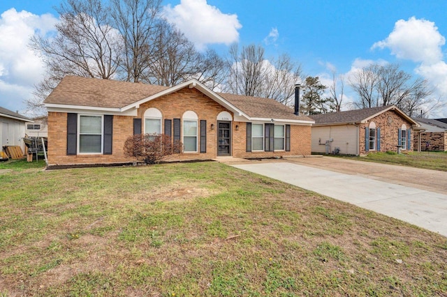 ranch-style house featuring driveway, brick siding, and a front yard