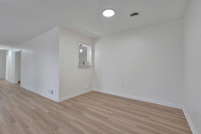 interior space with visible vents, baseboards, and light wood-style floors