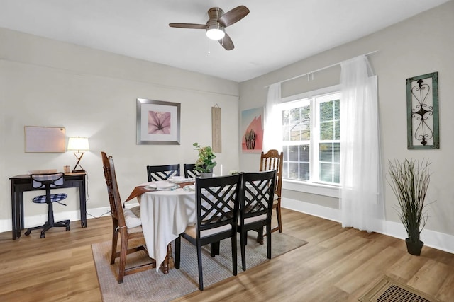 dining room with a ceiling fan, light wood-type flooring, and baseboards