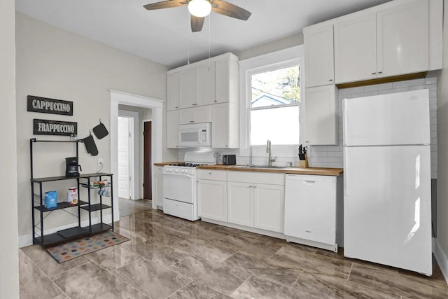 kitchen with butcher block countertops, a sink, white cabinetry, white appliances, and ceiling fan