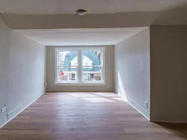 unfurnished room with wood finished floors