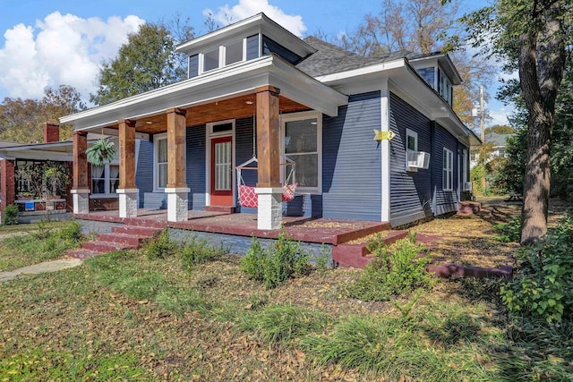 bungalow featuring cooling unit and a porch